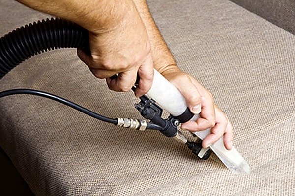 Low-moisture extraction cleaning bedding fabric in a San Antonio TX home